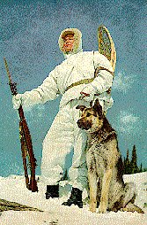 Snow Soldier with German Shepard on top of the mountain.